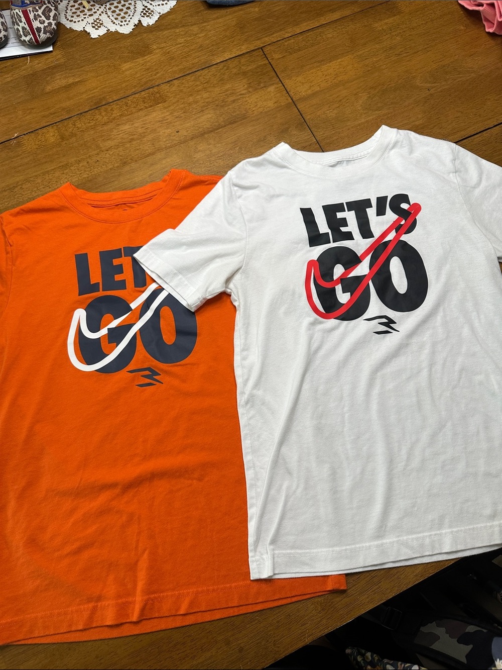 Nike Kids LET'S GO Tees in Orange with navy accents and White with red accents